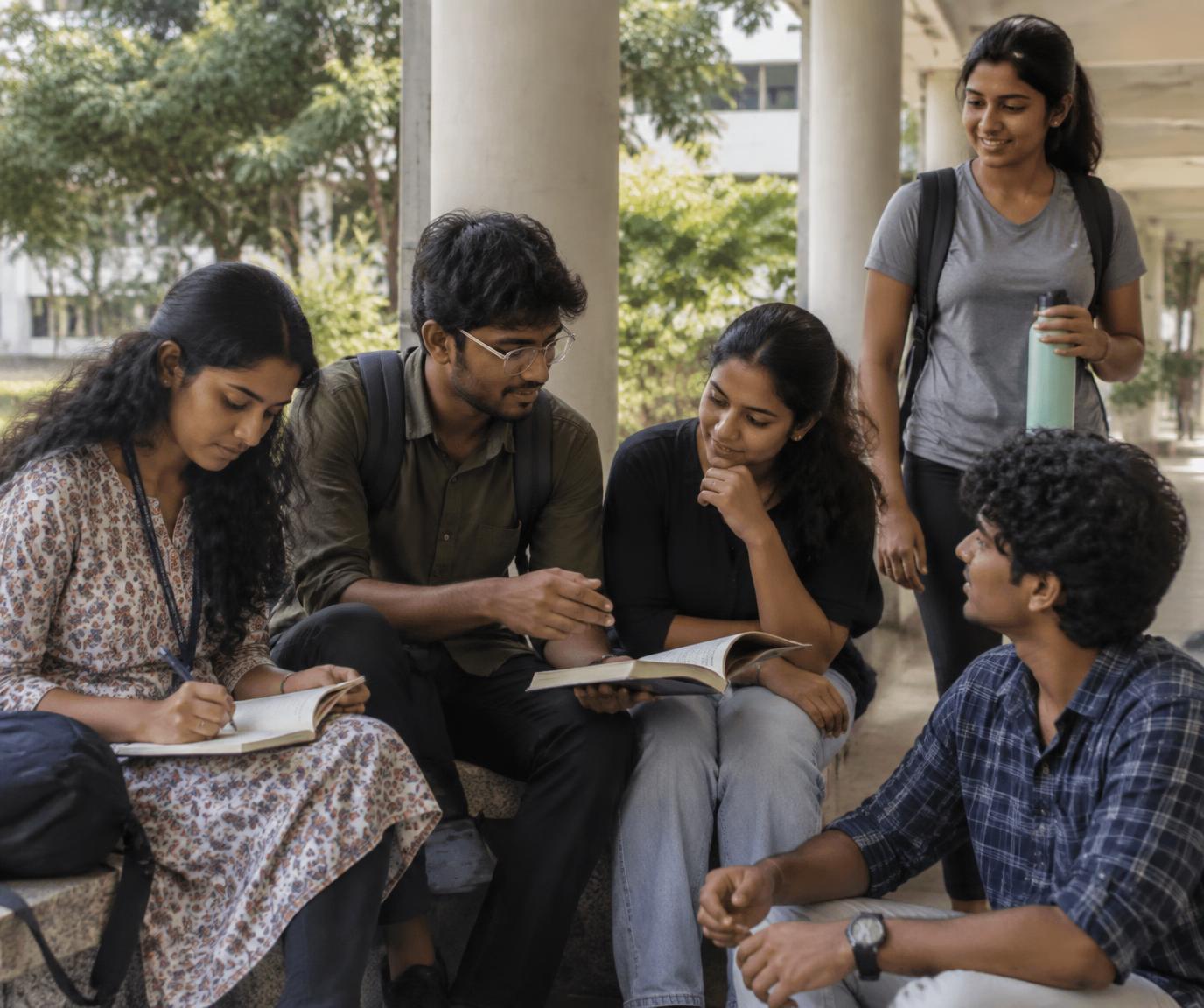 South Indian college students studying and discussing ideas together on campus